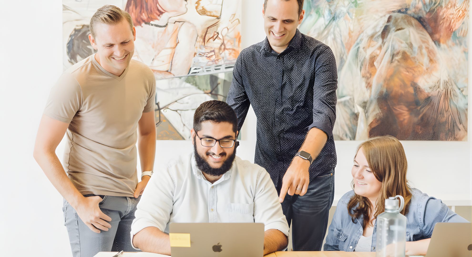 Diverse creative professionals collaborating in a bright, minimalist studio environment